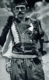 HAB48: “Peasant in Shijon with a gold-embroidered costume in black and white, and a colourful sash” (Photo: Hugo Bernatzik, 1929).