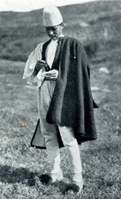 HAB53: “Southern Albanian peasant wearing a cloak and pointed shoes with black woollen pompons on them” (Photo: Hugo Bernatzik, 1929).