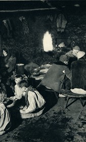 GM038: Dinner in a home in Okol in the Shala Valley, with the men, women and children at separate tables (Photo: Giuseppe Massani, 1940).