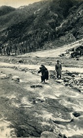 GM051: Father Anton Kiri being carried over the Shala River, with Giuseppe Massani behind him (Photo: Giuseppe Massani, 1940).